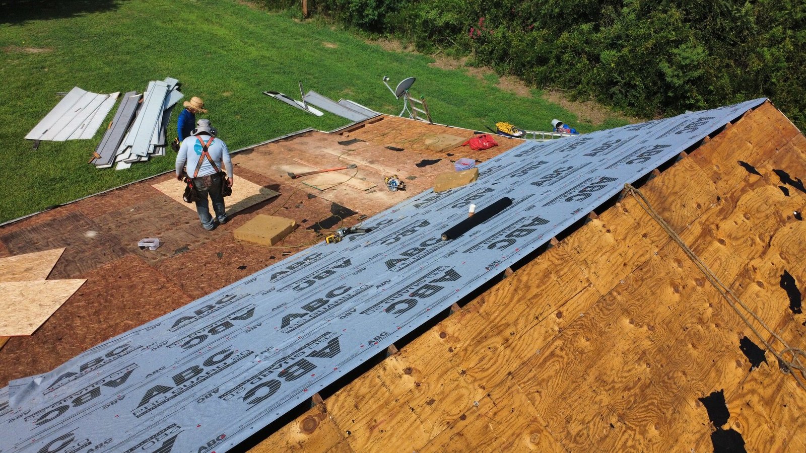 Synthetic roof underlayment being installed during a Cottageville, SC roof replacement.