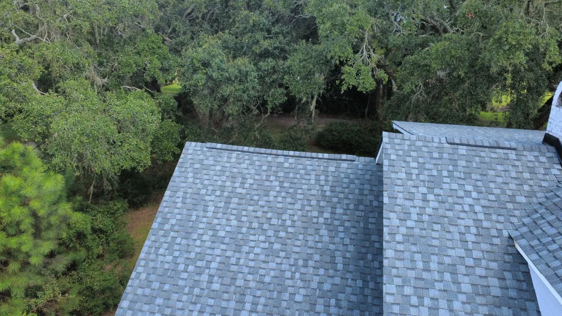 Shingle roof slopes, valleys and chimney flashing on a HopeStar Roofing project.